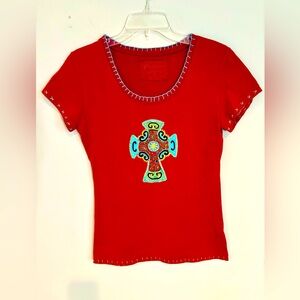 Women’s red cap sleeve tee with detailed embroidery and stitching.